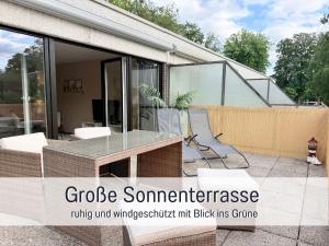 a patio with a glass table and a skate park at Wahlheimat Haffkrug, Strandnaher Ostseeurlaub, Terrasse, Tiefgarage und WLAN in Scharbeutz +39 photos