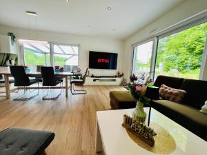 a living room with a couch and a table at Ferienhaus Waldblick in Hohenfels-Essingen