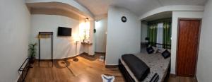 a living room with a couch and a television at GD Homestay in Shillong