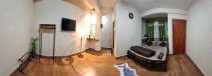 a living room with a couch and a tv at GD Homestay in Shillong