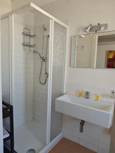 a white bathroom with a sink and a shower at B&B Torrefano in Portopalo +36 photos