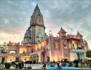 a building with a clock tower in front of it at Banaras Apartment Homestay 7BHK AC & NON AC ROOMS in KASHI VISHWANATH JYOTIRLING in Varanasi