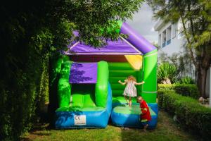 a little girl and a boy playing in a bounce house at Greek Village - Latchi הכפר היווני - כשר in Polis Chrysochous