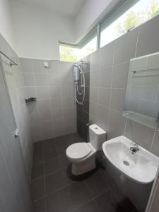 a bathroom with a toilet and a sink at Exclusive Changlun Room in Bukit Kayu Hitam