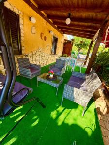 a group of chairs and a table on a patio at Villa Sant Anna in Alghero