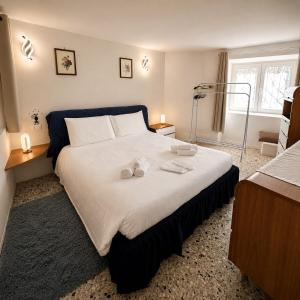 a bedroom with a large bed with two towels on it at Tra i laghi lago maggiore e lago d'orta in Invorio Inferiore