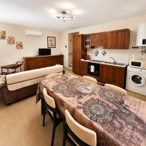 a kitchen with a table and chairs in a room at Tra i laghi lago maggiore e lago d'orta in Invorio Inferiore
