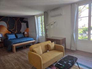 a living room with a couch and a chair at La demeure de Chambord in La Ferté-Saint-Cyr