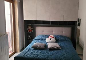 a teddy bear sitting on a bed with pillows at L'Officina in Leverano