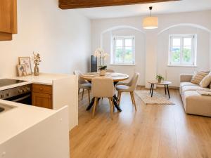 a kitchen and living room with a table and a couch at Riverside Ybbs - Danube View in Ybbs an der Donau