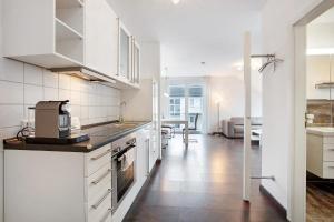 a kitchen with white appliances and a dining room at Weinregion direkt vor der Tür erleben - Ferienwohnung Weinberg in Bad Bellingen
