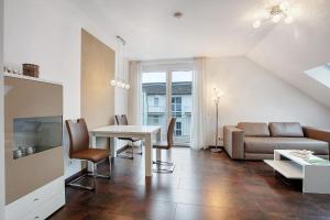 a living room with a couch and a table at Weinregion direkt vor der Tür erleben - Ferienwohnung Weinberg in Bad Bellingen