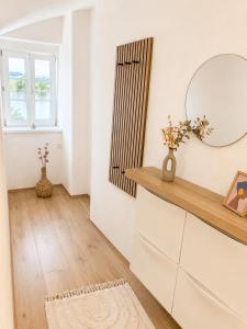 a dressing room with a mirror and a dresser at Riverside Ybbs - Danube View in Ybbs an der Donau