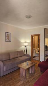 a living room with a couch and a coffee table at Aura Bay Cozy Studio in Kotor