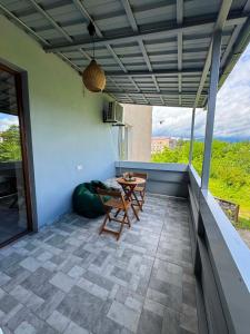 a patio with a table and chairs on a roof at Tskaltubo Kolkheti Apartment in Tsqaltubo