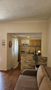a living room with a couch and a kitchen at Aura Bay Cozy Studio in Kotor