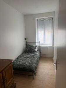 a bed in a room with a window at Maison campagne proche A75 in Vergongheon +2 photos