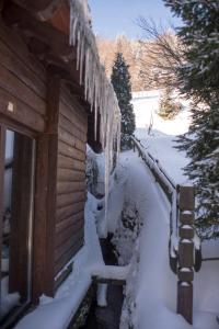 een huis met ijspegels in de sneeuw bij Gościniec Salmopolski in Szczyrk