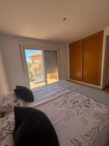 a bedroom with a large bed with a large window at Casa Golf Mar Menor in Los Martínez +13 photos