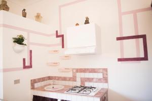 a bathroom with a sink and a stove at Chibedda Dimora Cesca in Castellammare del Golfo