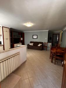 a living room with a couch and a table at Locazione Turistica Antonella in Fiumicino