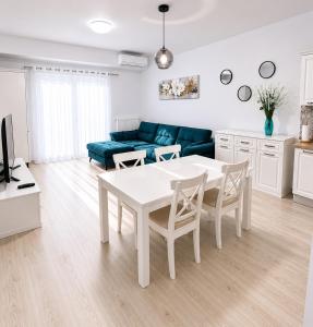 a living room with a white table and a couch at Eqinox apartments in Mamaia Sat/Năvodari