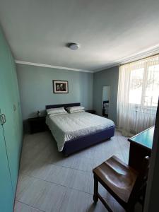a bedroom with a bed and a table in it at Locazione Turistica Antonella in Fiumicino