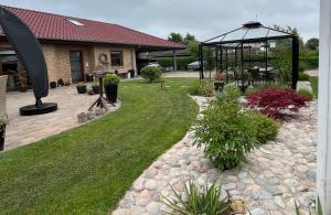 a backyard with a gazebo and a yard with grass at Driverhuset B&B in Grindsted