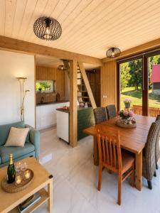 a kitchen and living room with a wooden table and chairs at Novoveská chaloupka in Stříbrná +15 photos