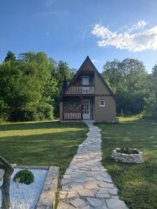 a house with a stone path in front of it at Cottage Bellis in Pošćenje