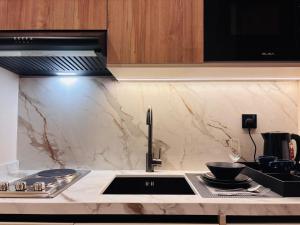 a kitchen with a sink and a counter top at Voyage Expo Suites in Riyadh