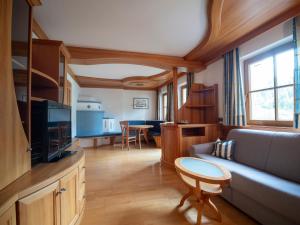 a living room with a couch and a tv at Apartment Vernel in Santa Cristina Gherdëina