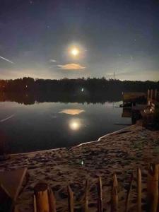 a view of a body of water at night at Strandvilla met sauna in Westerhaar-Vriezenveensewijk +46 photos