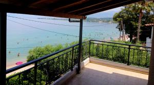 a balcony with a view of the beach at xanthi's sea front villas in Flámbouras