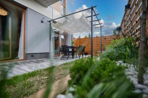 a patio with a table and chairs on a house at Wejdz na Housine,pl Zator in Zator