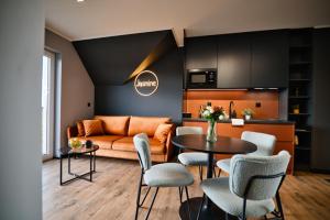 a living room with an orange couch and a table at Wejdz na Housine,pl Zator in Zator