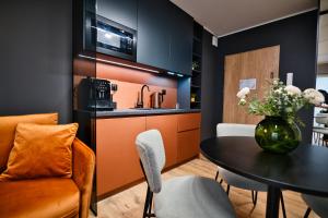 a kitchen and dining room with a table and a couch at Wejdz na Housine,pl Zator in Zator +13 photos