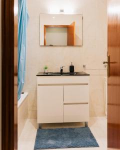 a bathroom with a sink and a mirror at Lourença Stays - Vila Beach Apartment 1 in Vila do Conde +22 photos