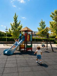 a group of children playing on a playground at Lourença Stays - Vila Beach Apartment 1 in Vila do Conde