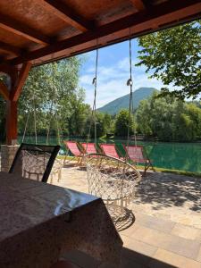 a group of chairs on a patio with a swing at Villa Una Bellevue in Bihać