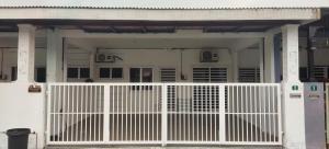 a white gate in front of a house at Angah Homestay in Kampong Chabang +3 photos