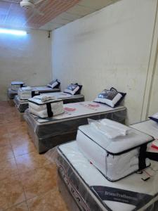 a group of mattresses lined up in a room at نزل مشترك هوستيل in Khamis Mushayt