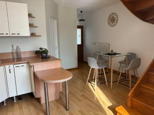 a kitchen and dining room with a table and chairs at Appartement - Baume-les-Dames in Baume-les-Dames
