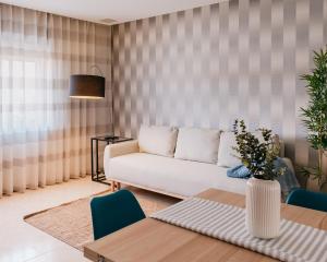 a living room with a couch and a table at Lourença Stays - Vila Beach Apartment 1 in Vila do Conde
