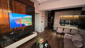 a living room with a flat screen tv on a wall at Wejdz na Housine,pl Zator in Zator