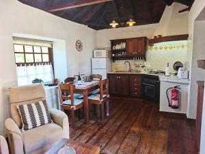 a kitchen with a table and a dining room at Panchita in Garafía