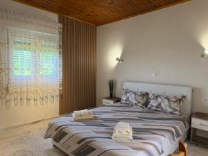 a bedroom with a large bed with two towels on it at AparDibra in Bar +34 photos