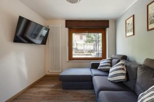 a living room with a couch and a flat screen tv at Residence Madamin in Fenestrelle