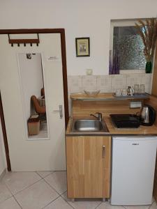 a small kitchen with a sink and a mirror at Studio Rada in Ulcinj