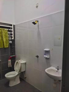 a bathroom with a toilet and a sink at Angah Homestay in Kampong Chabang